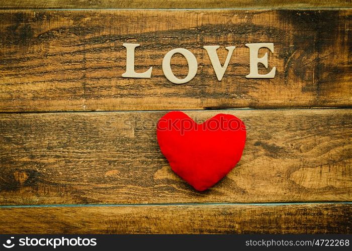 Red heart on a rustic wood. Beautiful card for Valentine?s Day