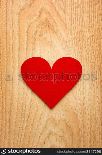 Red heart on the wooden background