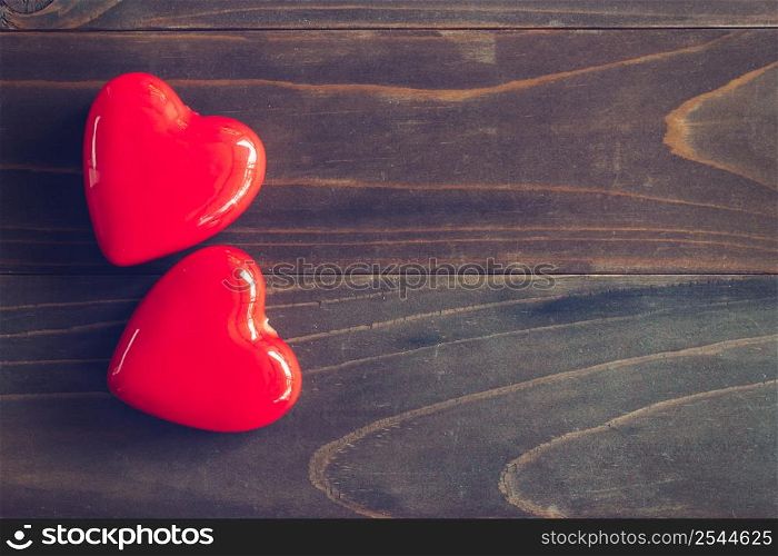 red heart on wood table background with copy space