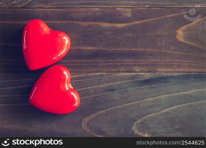 red heart on wood table background with copy space
