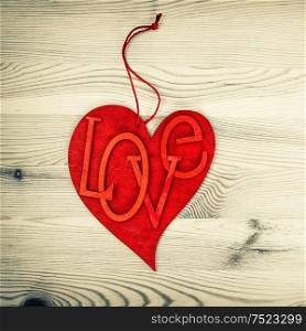 Red Heart On Wooden Background. Love and Valentines Day Concept. Vintage Style Toned