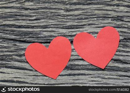 Red Heart paper on the wooden floor and have copy space for design in your love or Valentine day Concept.