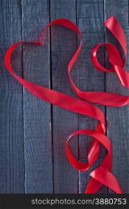 red heart ribbon on the wooden background