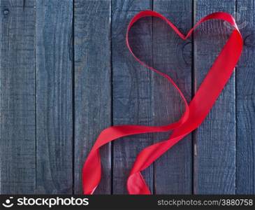 red heart ribbon on the wooden background