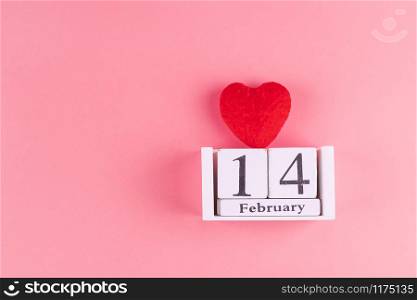 Red heart shape decoration with 14 February calendar on pink background. Love, Wedding, Romantic and Happy Valentine day holiday concept