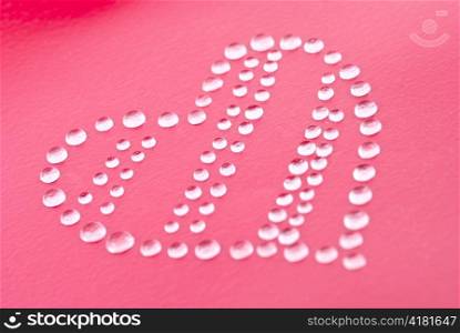 Red heart shape made of water droplets