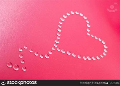 Red heart shape made of water droplets