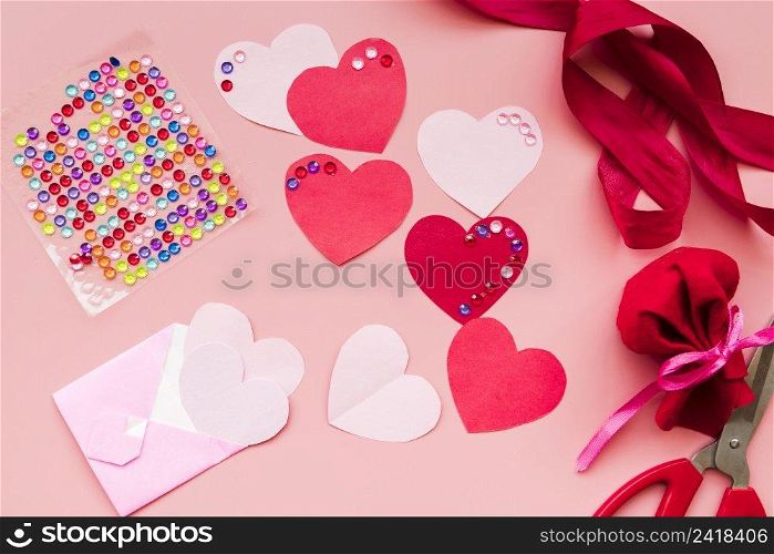 red heart shape with ribbons pink background
