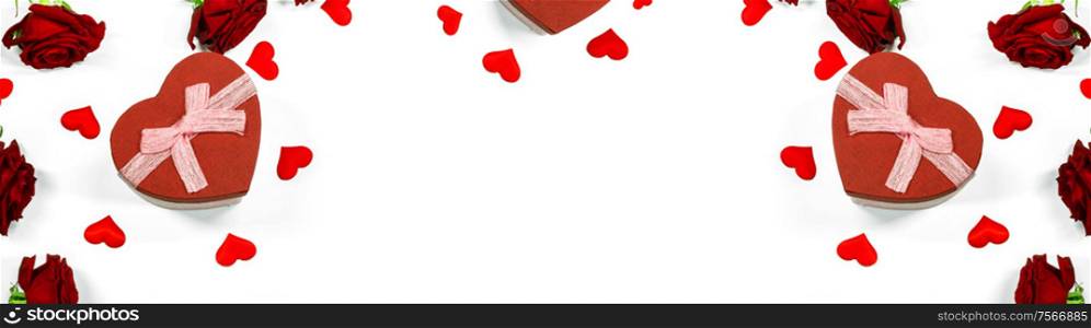 Red heart shaped gift box with roses and paper hearts isolated on white background. Red heart gift box with roses