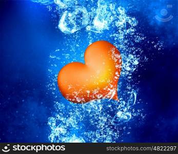 Red heart under water. Red love heart under clear blue water