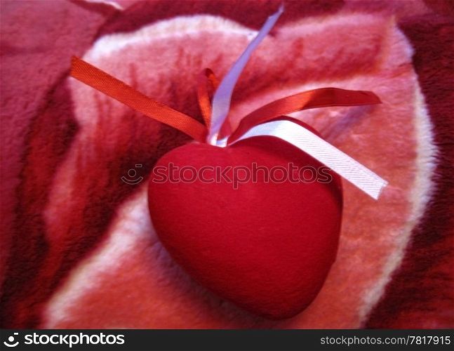 Red heart with red and white stripes on the pink background