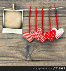 Red hearts and instant polaroid photo frame. Valentines Day concept. Mock up with space fot your photo
