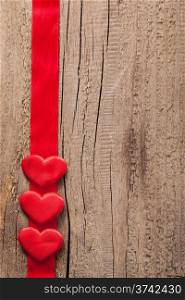 red hearts and ribbon frame wooden background for Valentines