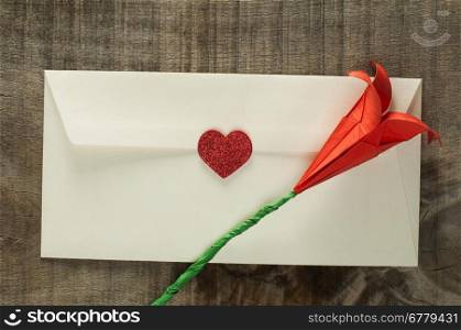 Red hearts and white envelope on wooden background
