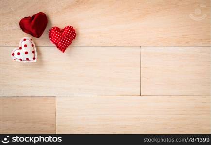 Red hearts handmade crafts from silk and cotton cloth place on wood texture with space, love and valentine&rsquo;s day symbol