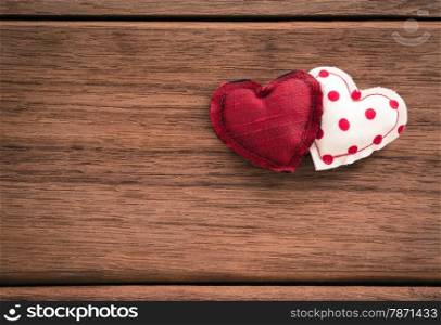 Red hearts handmade crafts from silk and cotton cloth place on wood texture, love and valentine&rsquo;s day symbol
