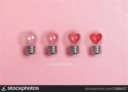 Red hearts in light bulbs. Loading progress bar on pink background. Valentine?s day, Creative idea, Love, Inspiration Concepts.