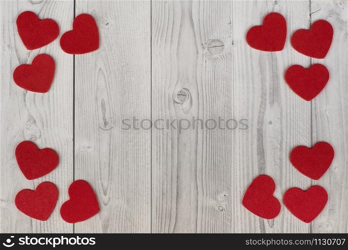 red hearts in the corners of a white and grey wooden background. concept of valentine's day