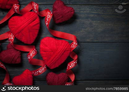 Red hearts made of wool on wooden background for Valentine&rsquo;s Day. Copy space. Top view