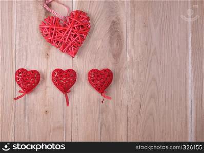 red hearts on a wooden background of oak boards, copy space