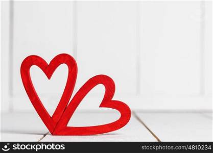 Red hearts on wood. Two red hearts on white wooden background
