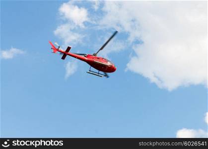 Red helicopter on the bright summer day
