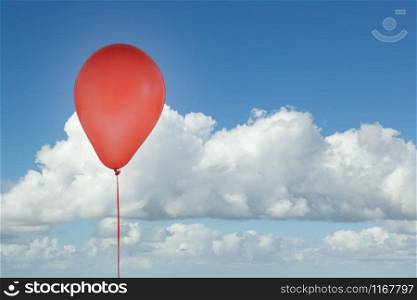 Red helium party balloon for birthday and celebrations isolated at blue sky with clouds and copy space for free text. Red balloon isolated at blue sky with clouds