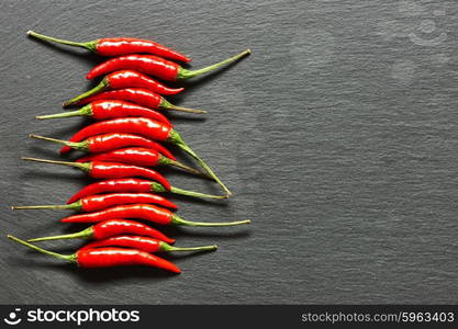 Red hot chili peppers on slate background