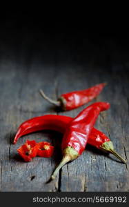 Red hot chili peppers over wooden background