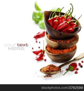 Red Hot Chili Peppers with herbs and spices over white background - cooking or spicy food concept