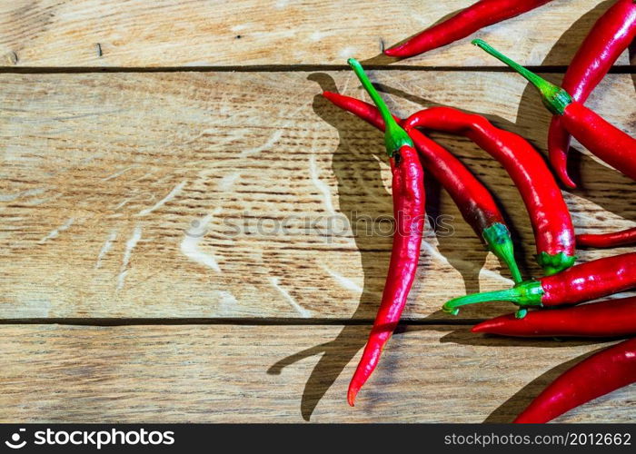 Red hot peppers on wooden table