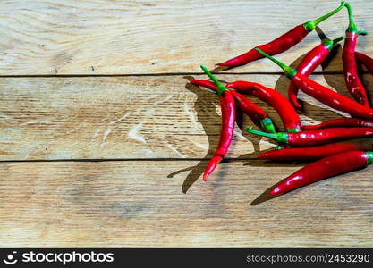 Red hot peppers on wooden table