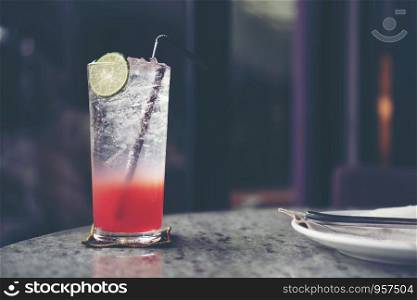 red Italian soda with lemon and strawberry