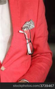 Red jacket handkerchief and glasses in his buttonhole