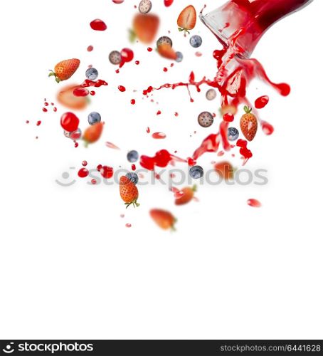 Red juice or smoothie drink is poured out of glass bottle with splash and berries ingredients, isolated on white background, front view. Healthy summer beverage concept