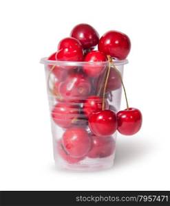 Red juicy sweet cherries in a plastic cup isolated on white background