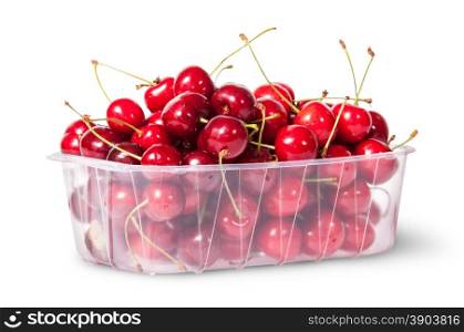 Red juicy sweet cherries in a plastic tray rotated isolated on white background