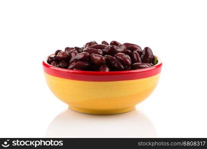 Red kidney beans in a dish in perspective. Isolated on white.