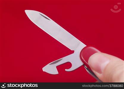 Red knife isolated on red background