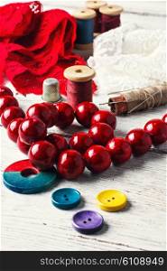 Red lace,beads and tools of the artisan jewelry.