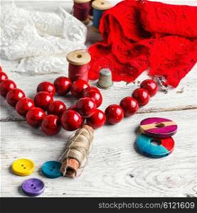 Red lace,beads and tools of the artisan jewelry.