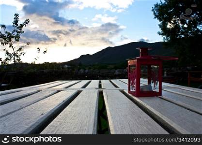 Red lamp on a table during sunset. Good for conceptual of rest and relax.