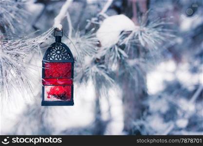 Red lantern on the snowy tree
