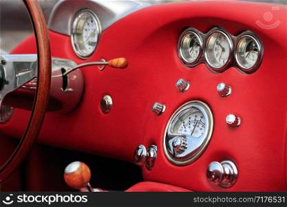 Red leather interior of classic cabriolet car.