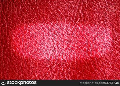 Red leather texture closeup grunge background with bright oval design copy space for text