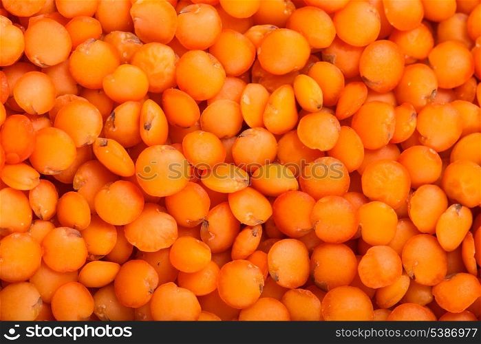 red lentils heap closeup as a background