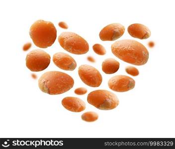 Red lentils in the shape of a heart on a white background.. Red lentils in the shape of a heart on a white background
