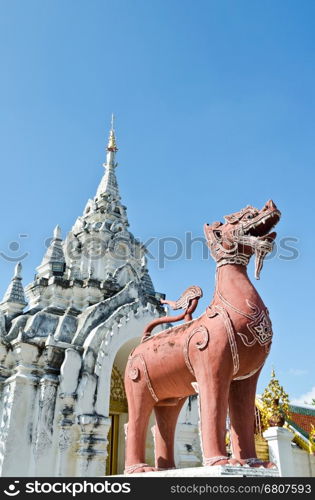 Red Lion statue at front Wat Phra That Hariphunchai temple in Lamphun Province of Thailand