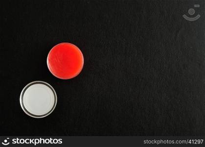 Red lip palm in a jar with a lid isolated on a black background