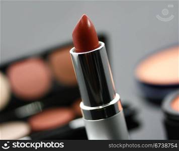 . Red Lipstick And Other Cosmetics On The Table